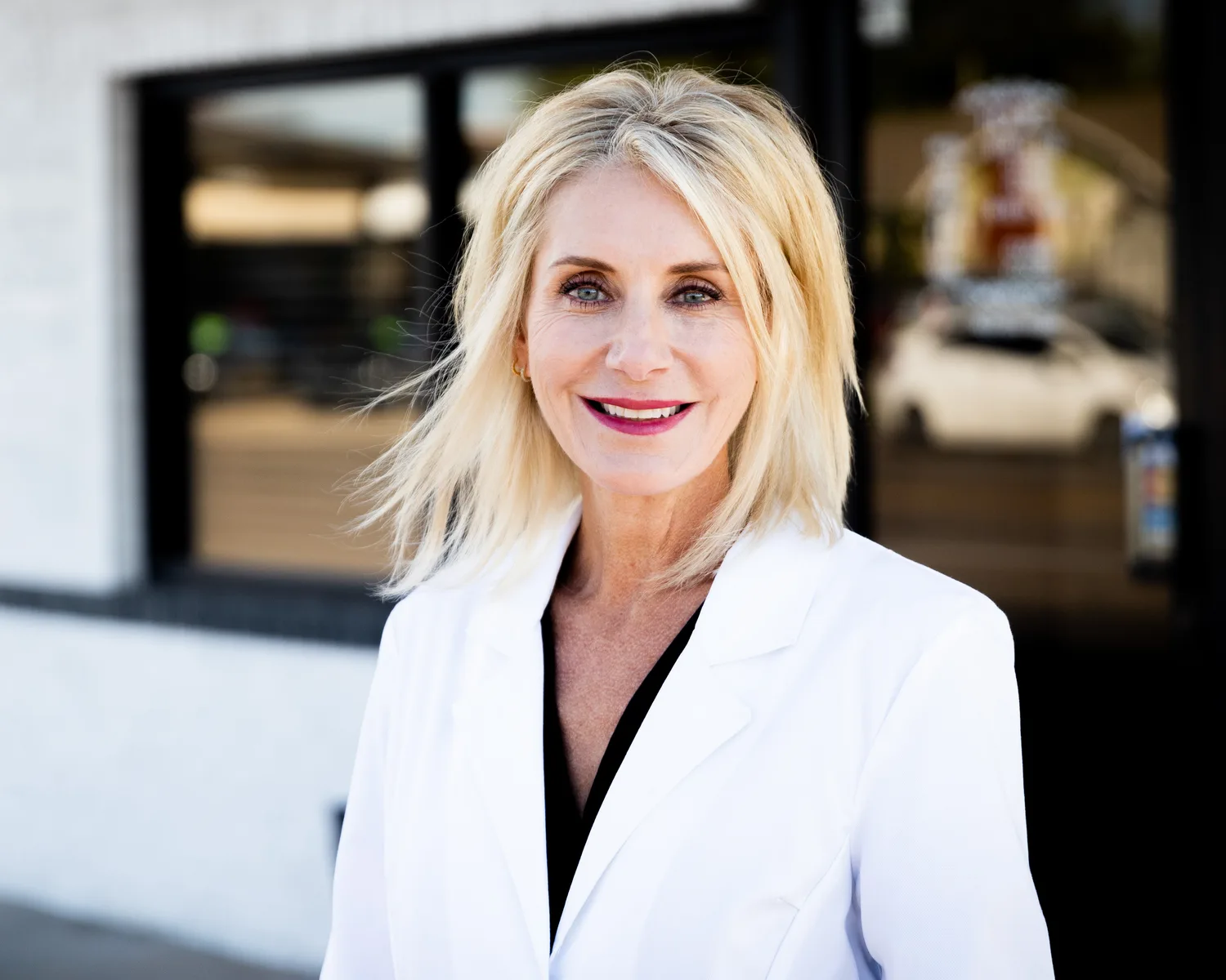 Dr. Amy Croom, in a white coat, outside Berry Road Dental in Norman
